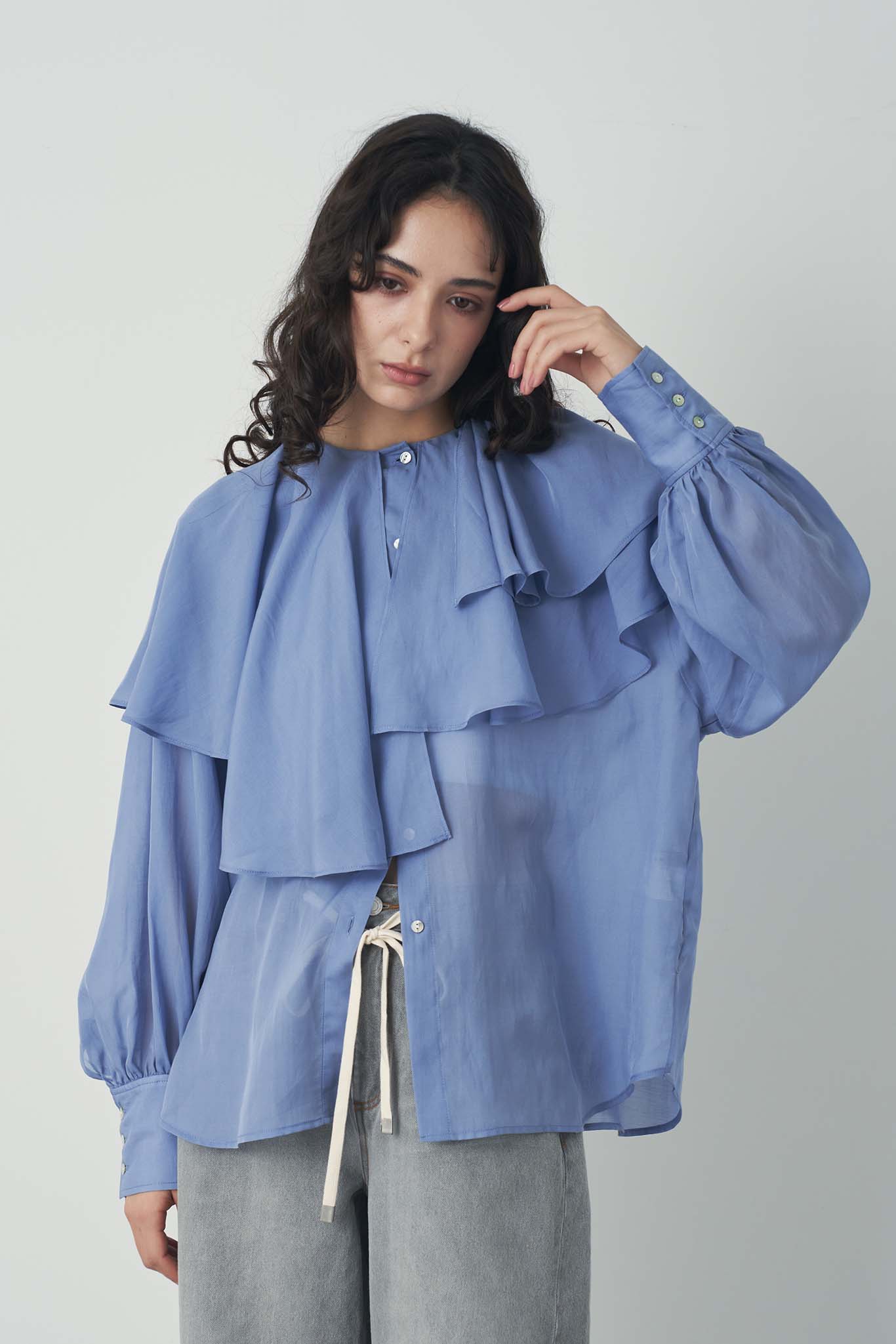 シアアシメラッフルブラウス